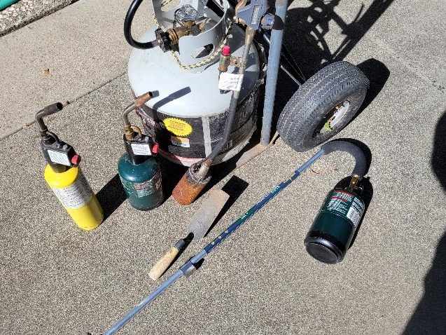A collection of propane-fueled weed burners.