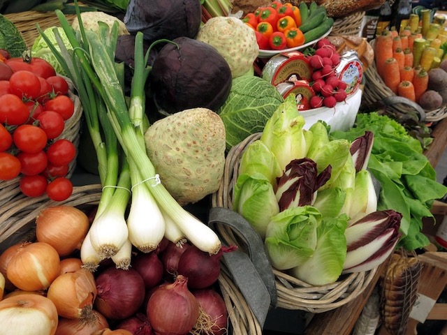 Baskets of onions, tomatoes, endives, etc.