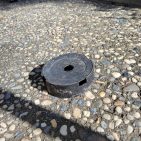 The cut-off base of a pot with a hole in the center.