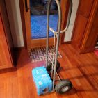 A hand truck carrying a pack of water.