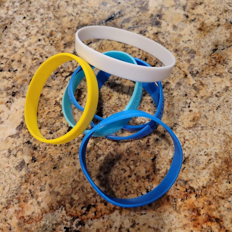 A group of wristbands on a counter.