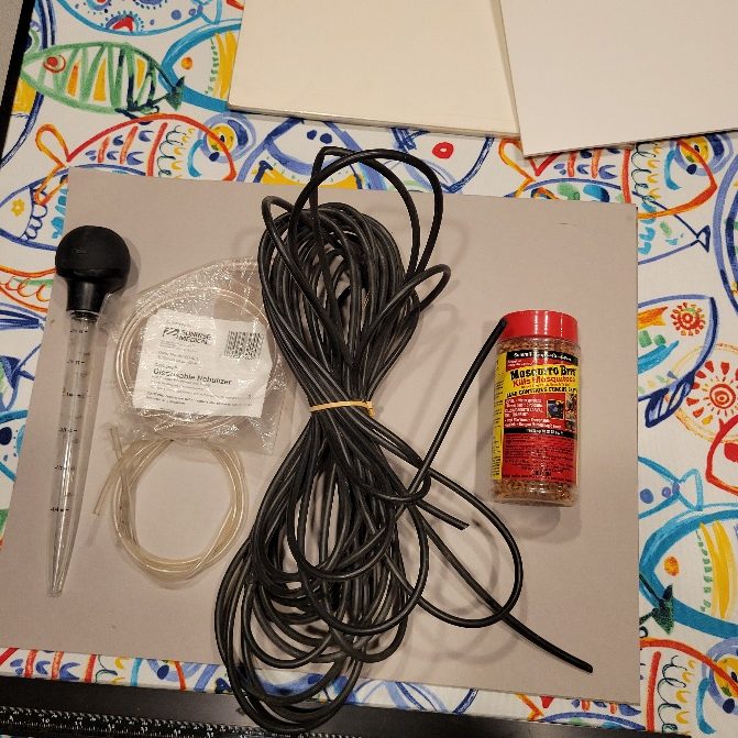 A turkey baster, some bundles of tubing, and a spice jar of mosquito killer.